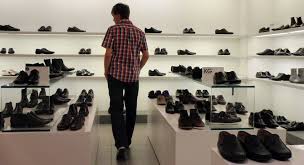 Man in a shoe store and looking for shoes