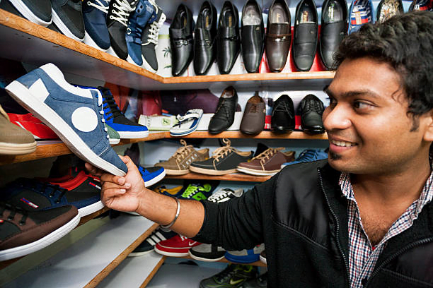 A man searching casual shoes for wide feet in a shoe store 